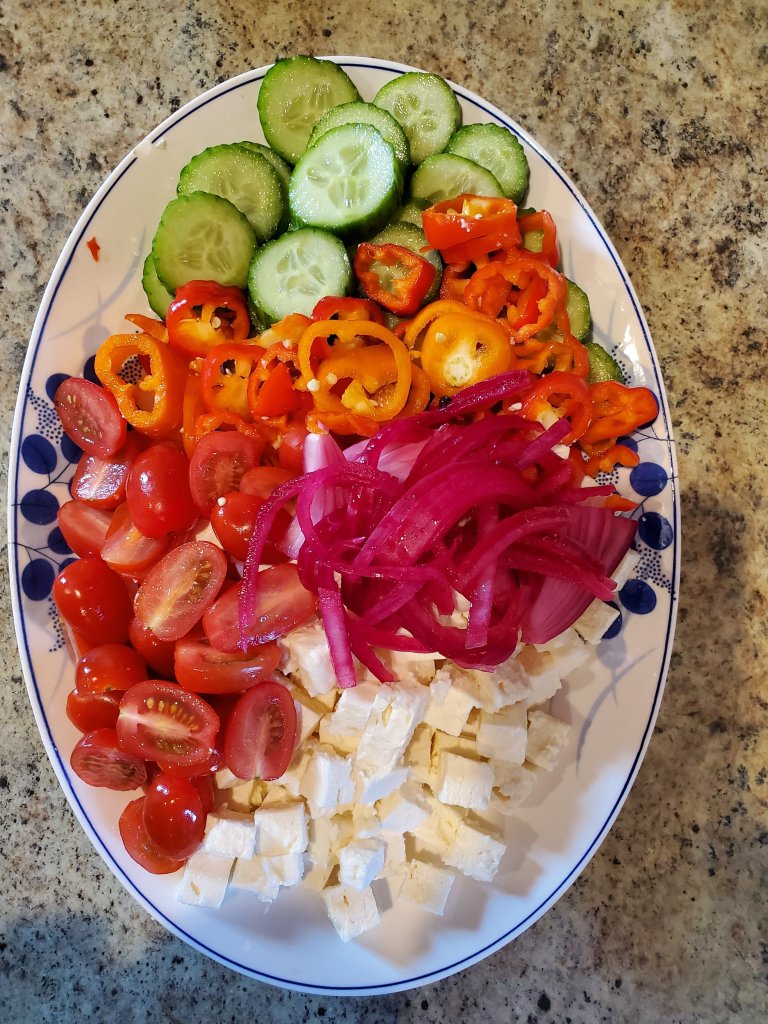 Greek salad deconstructed. tomatoes, feta, pickled red onions, bell peppers, cucumbers